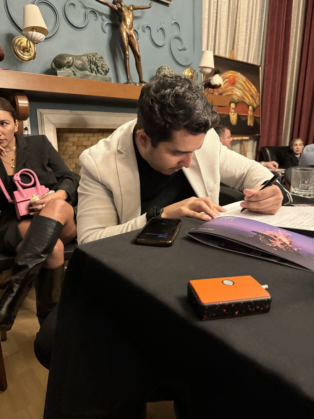 Vinny Govea signing offers at the activation event of a Tulum residential development, name withheld under NDA.