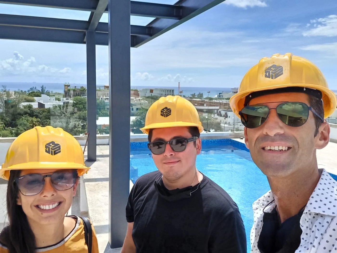 Vinny Govea and team in FEUDO hard hats on a rooftop inspection in Tulum.